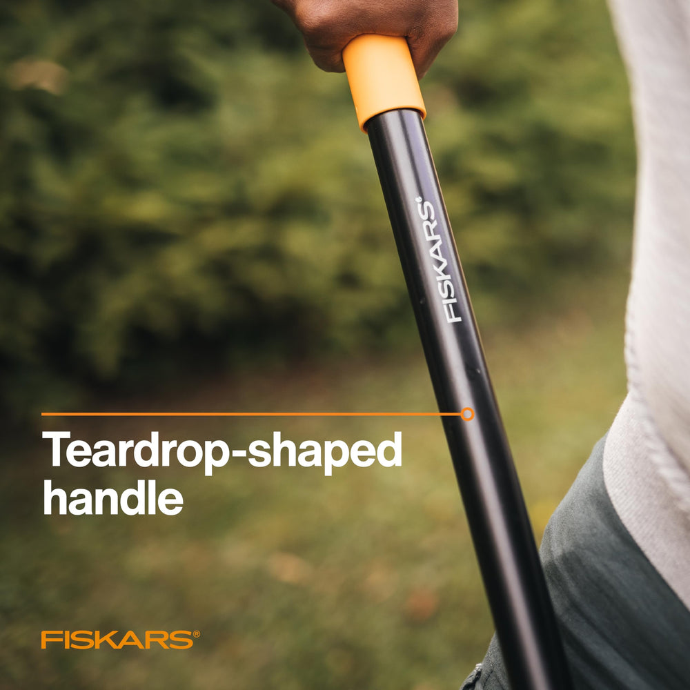 Fiskars sharpened blade cutting turf edge showing clean-cut landscaping benefit