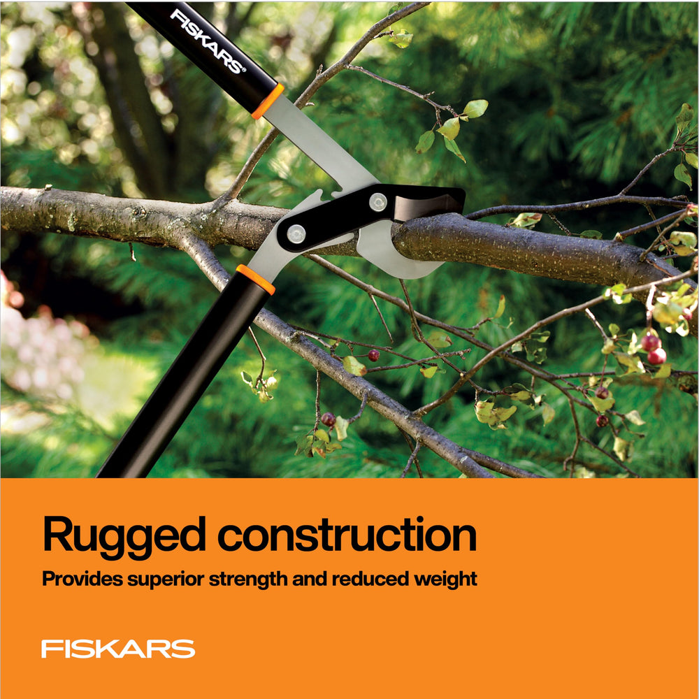 Fiskars lopper beside ruler showing 32-inch length and 2-inch cut capacity