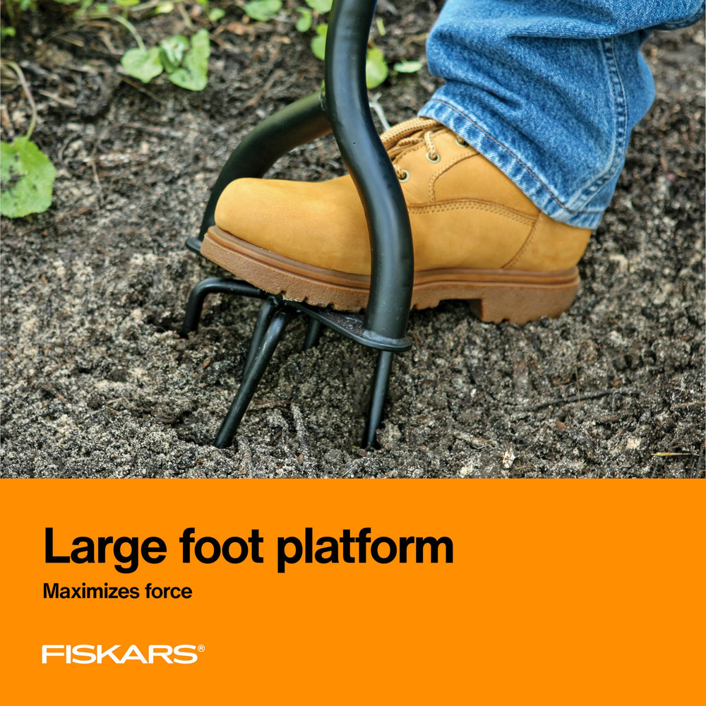 Close-up of Fiskars arrow-tipped tines penetrating soil, efficient clod breaking benefit