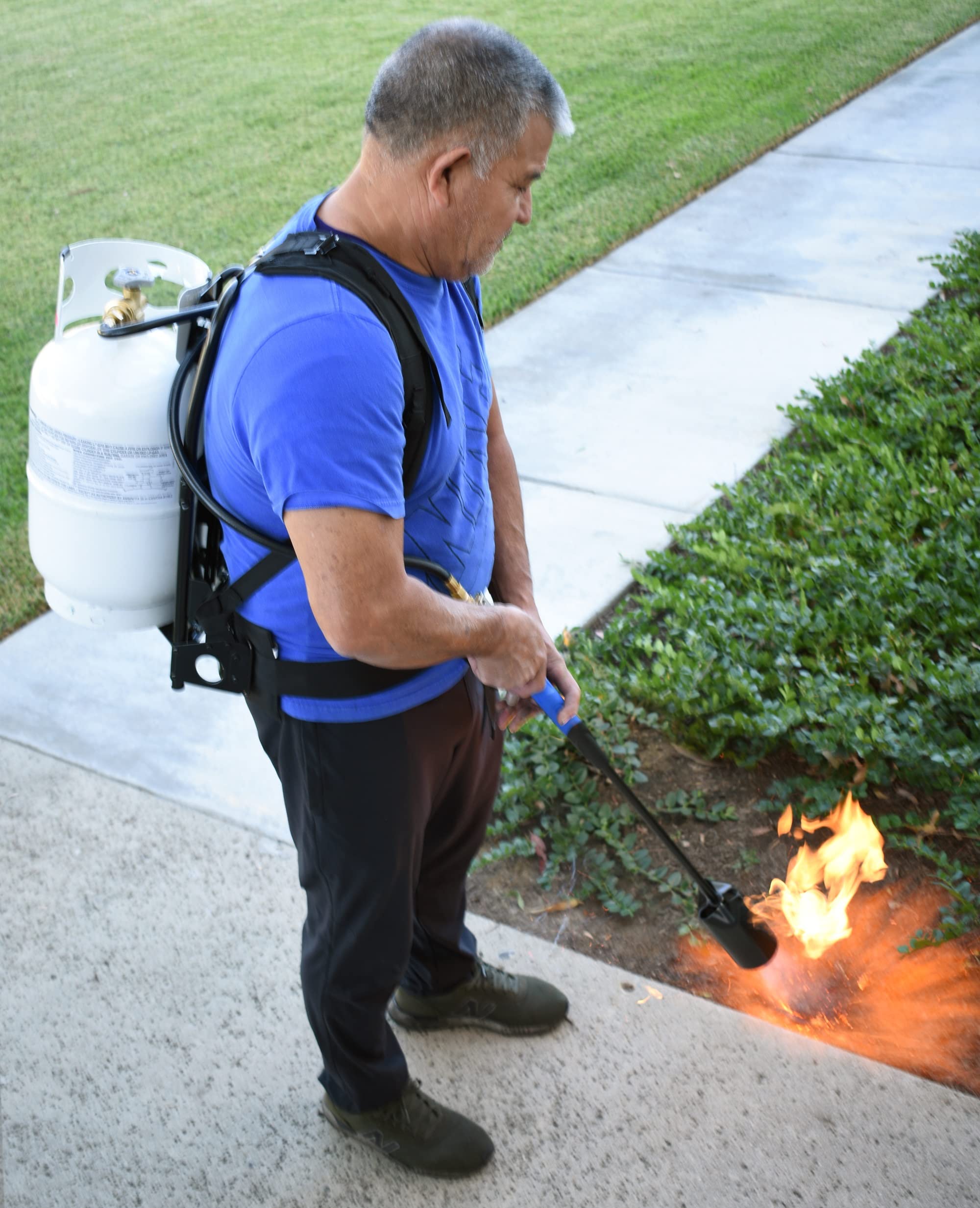Flame King carrier on person next to tank for clear size and scale