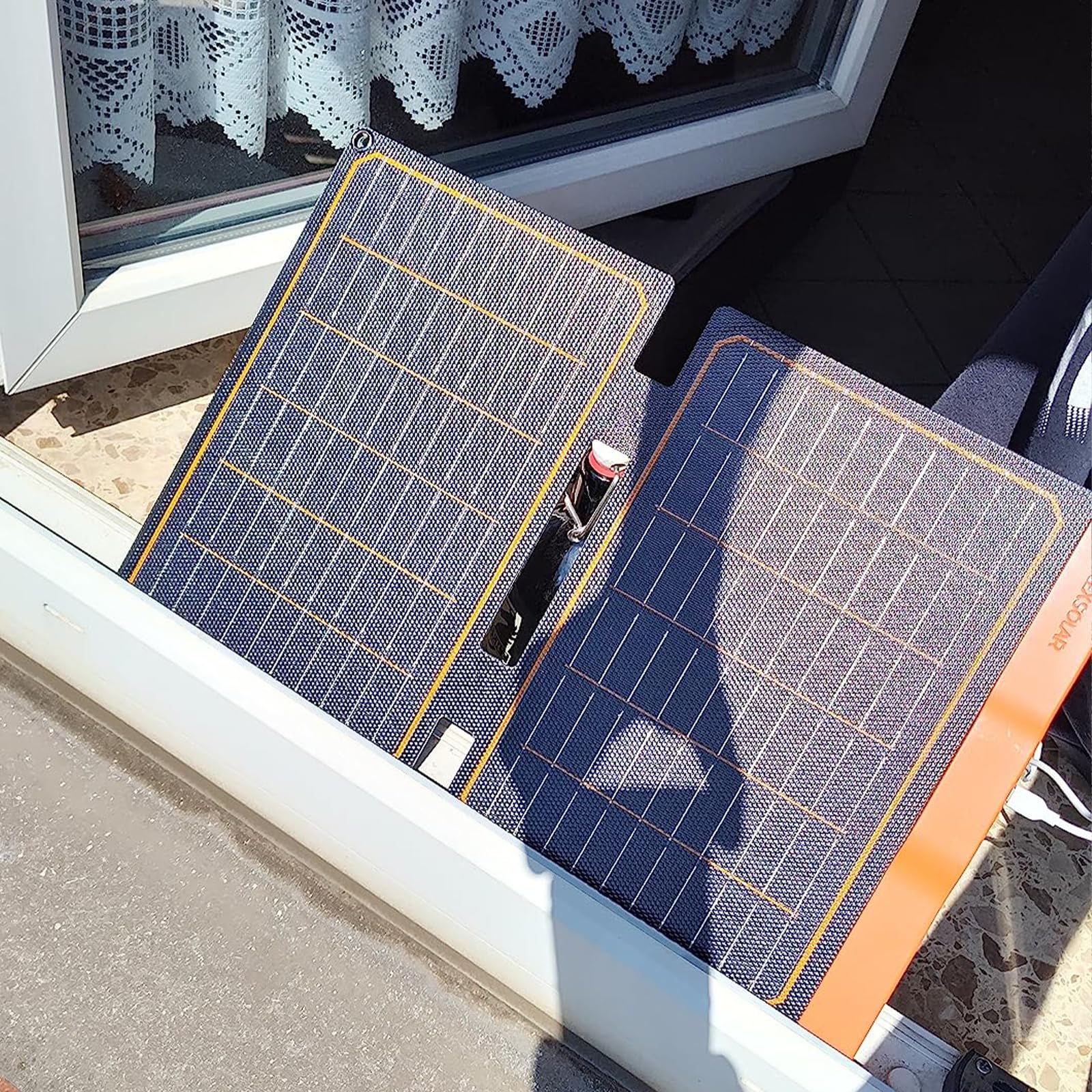 FlexSolar packaging with two carabiners and manual showing included accessories