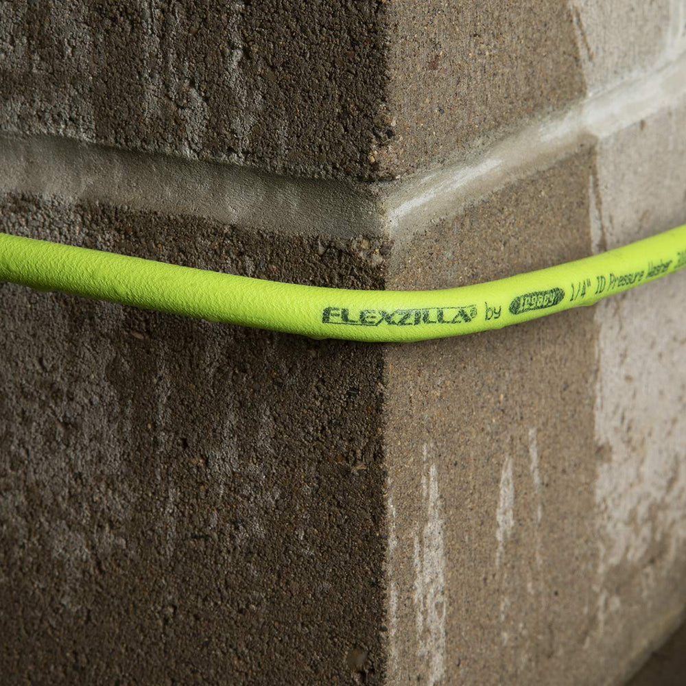 Flexzilla 50 ft hose coiled next to a foot for scale showing extended reach