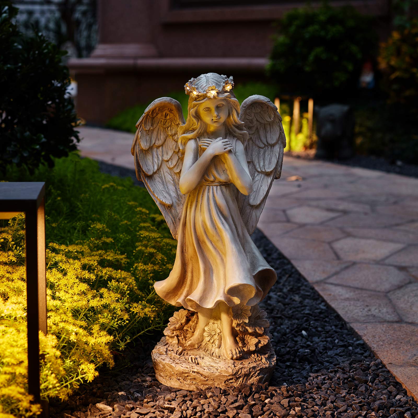 Floryden angel placed in a garden showing peaceful decor benefit
