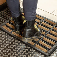 FOOTMATTERS Ninamar in use with boot scraping outdoors keeping porch clean