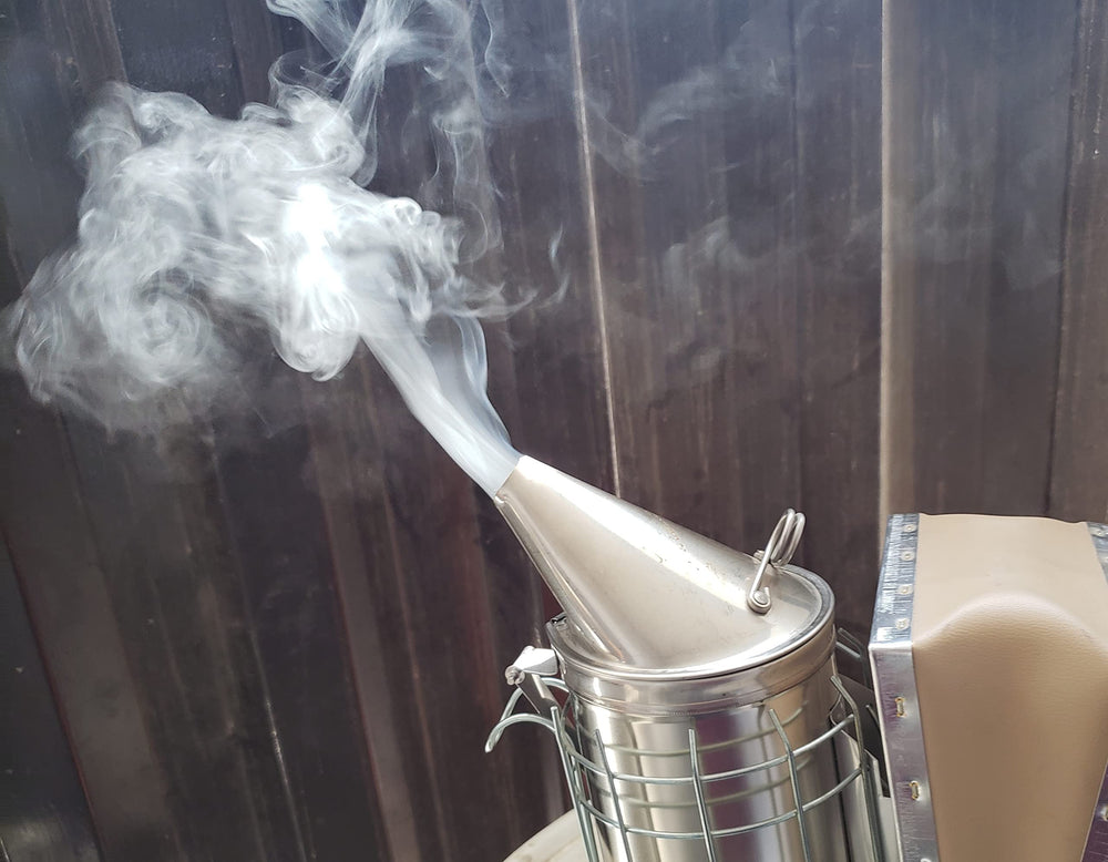 FOREST BEEKEEPING SUPPLY smoker in use creating cool smoke for calmer hive work