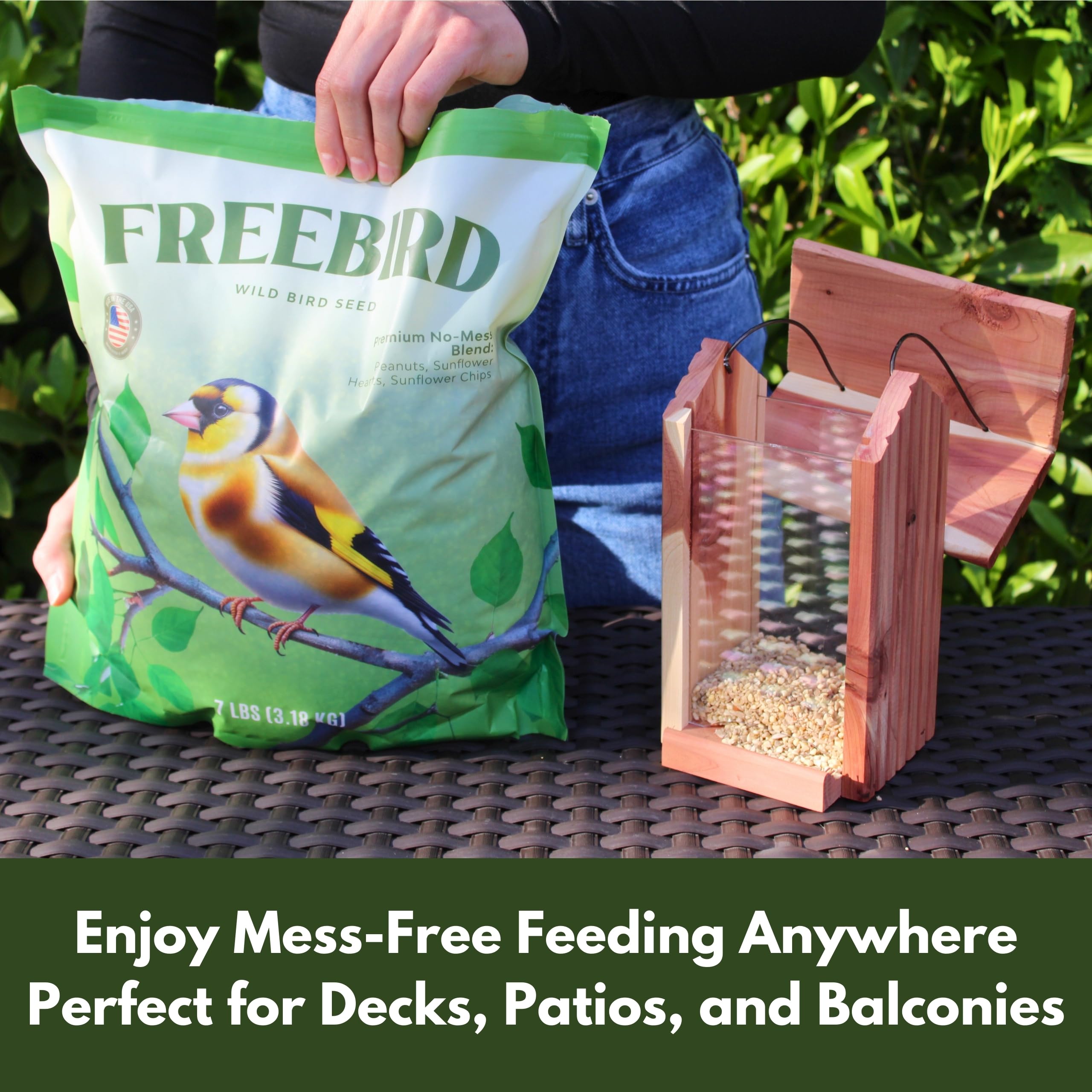 FREEBIRD hand holding mix to show seed size and 7 lb bag portion scale