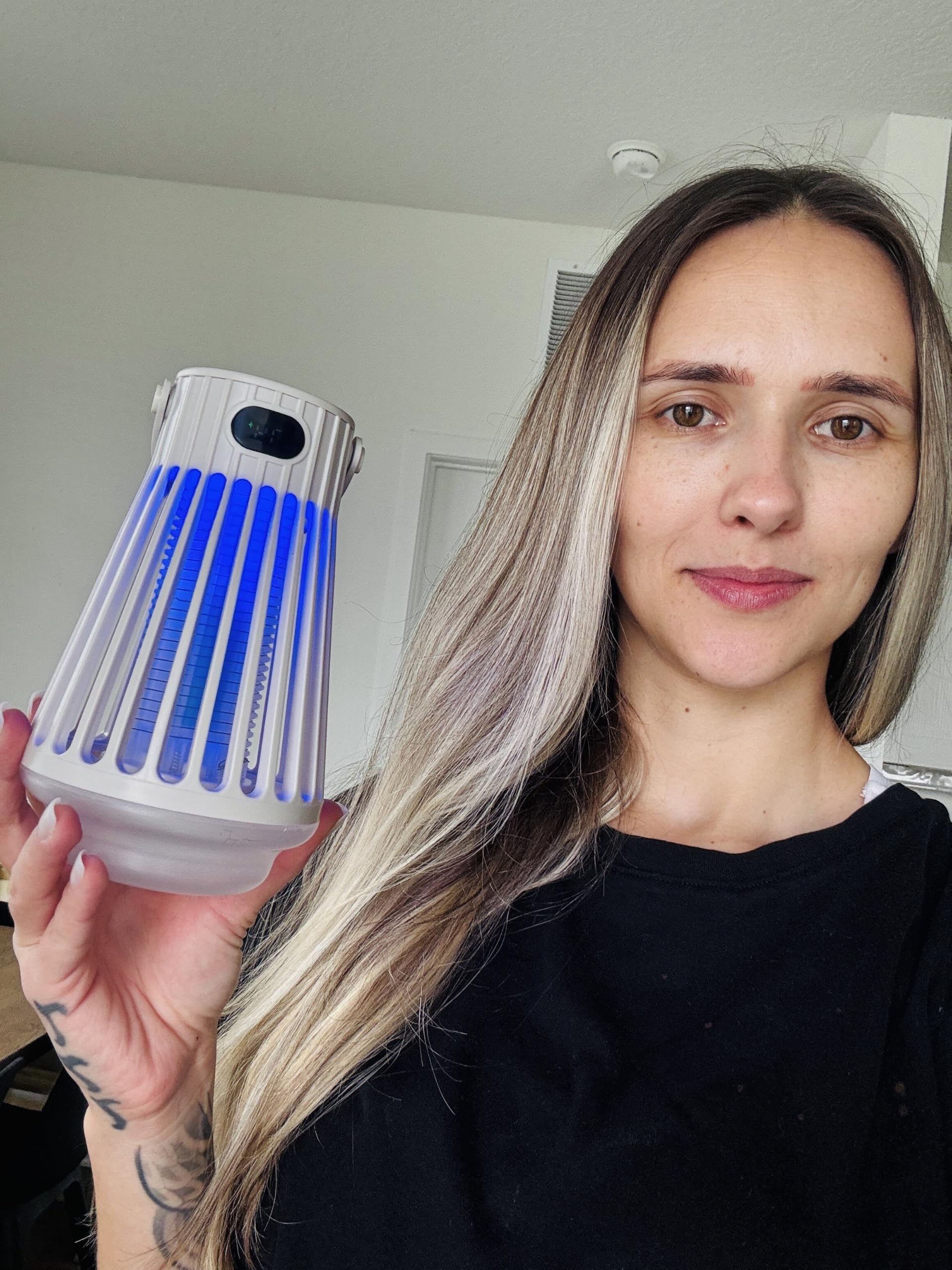 FREEZE2TRIM next to a water bottle for scale showing compact, travel-ready size