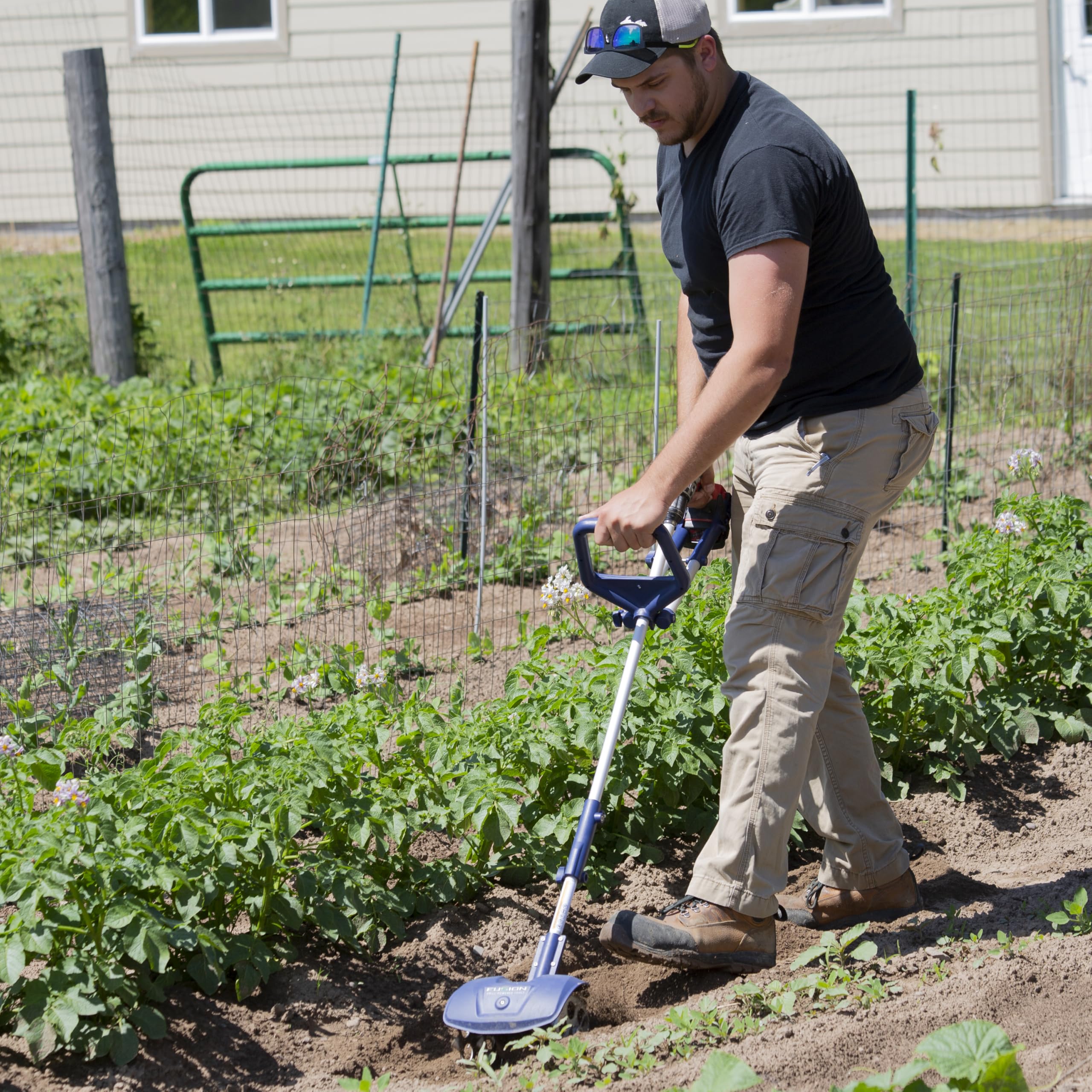 Fusion Drill Powered Tools close-up of four steel tines cutting soil for effective weeding