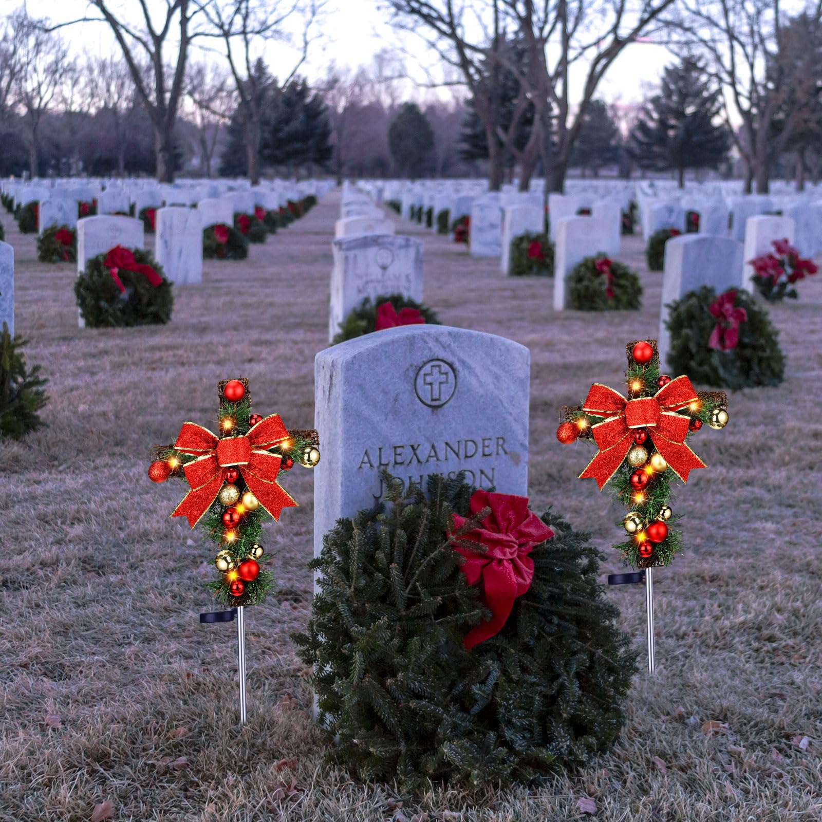Ganeen lit cross stakes at night offering visible gentle illumination for graves