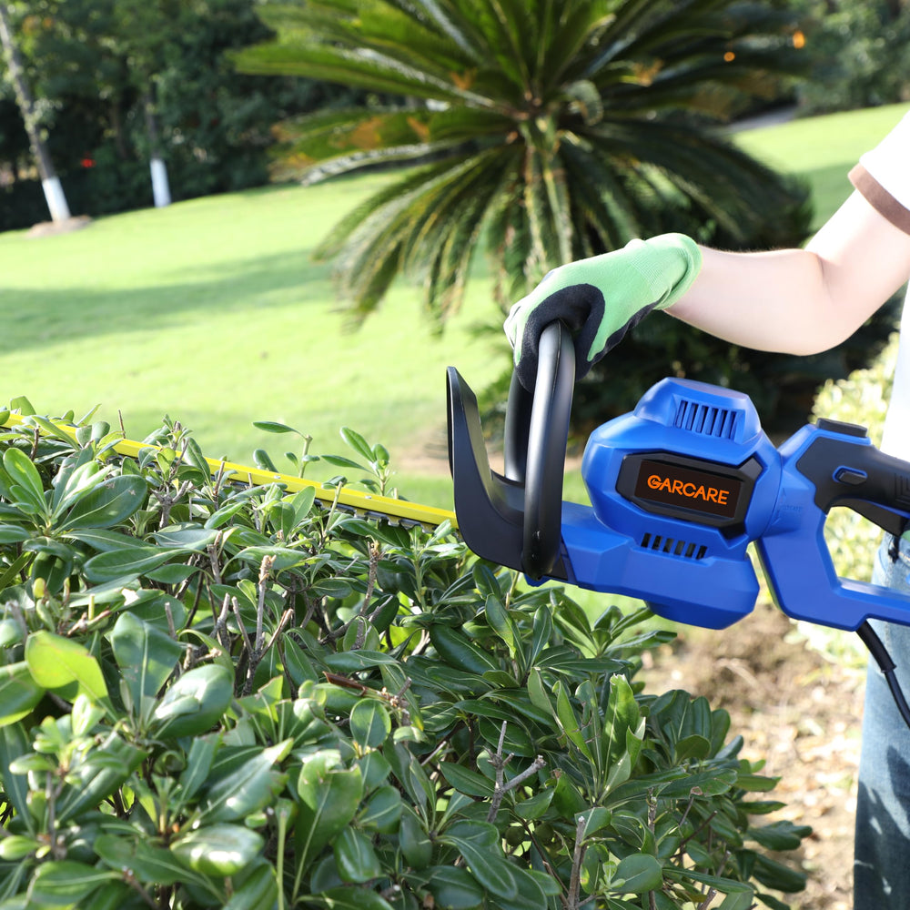 GARCARE trimmer in use on hedges demonstrating precise shaping in a garden setting