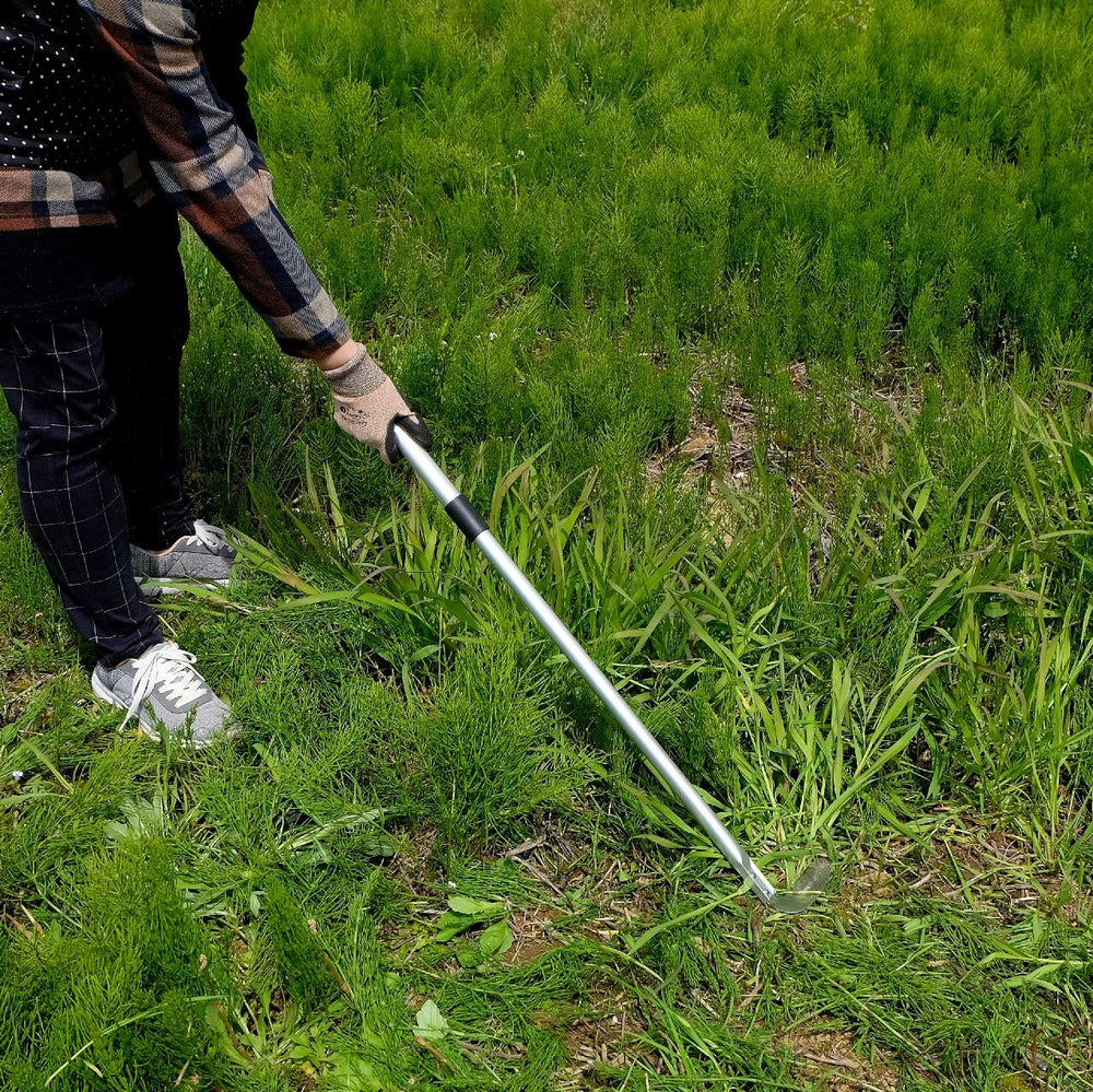 Garden Helper extended telescoping handle in garden demonstrating comfortable stand-up weeding