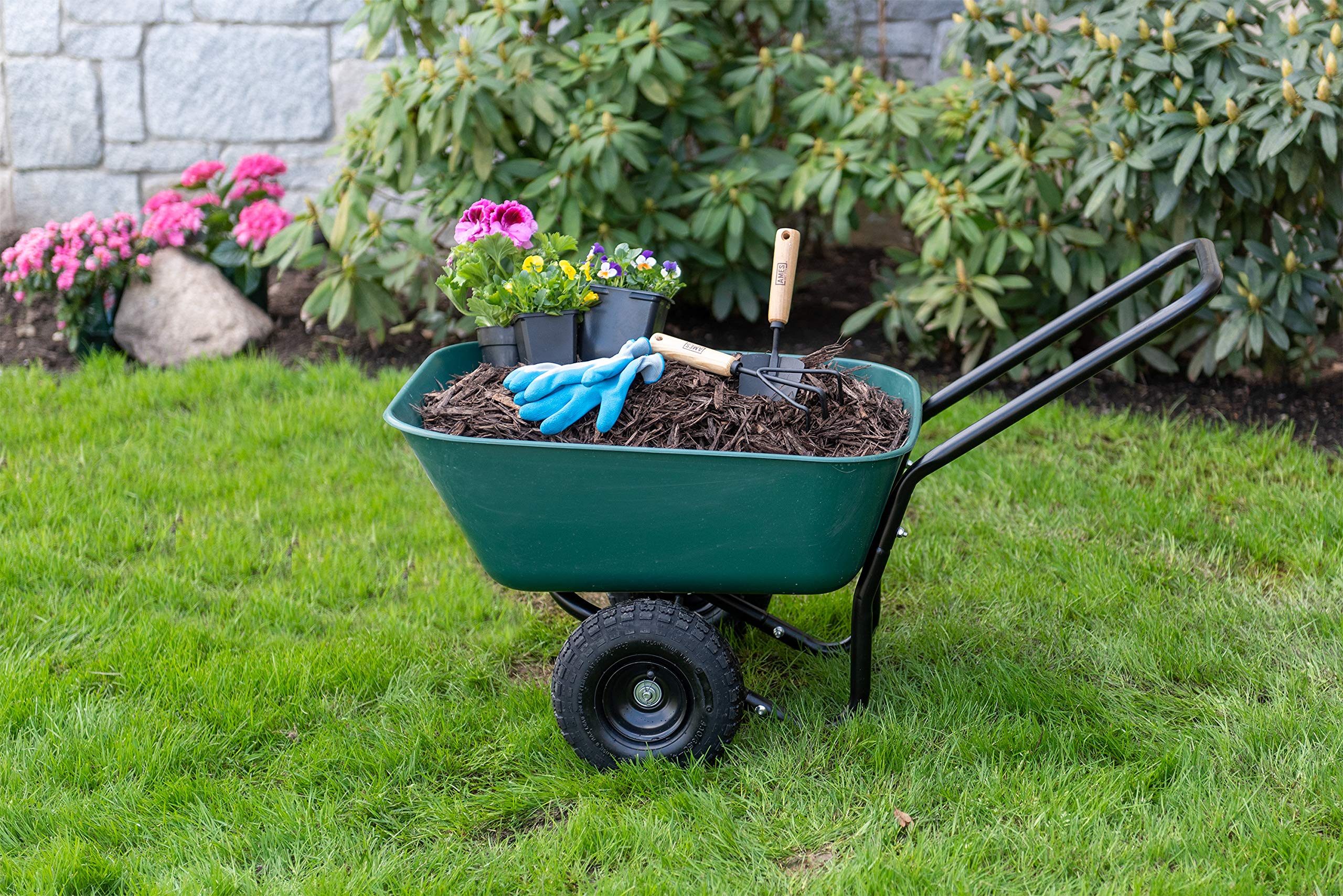 GARDEN STAR in-use moving mulch in a backyard to speed garden work