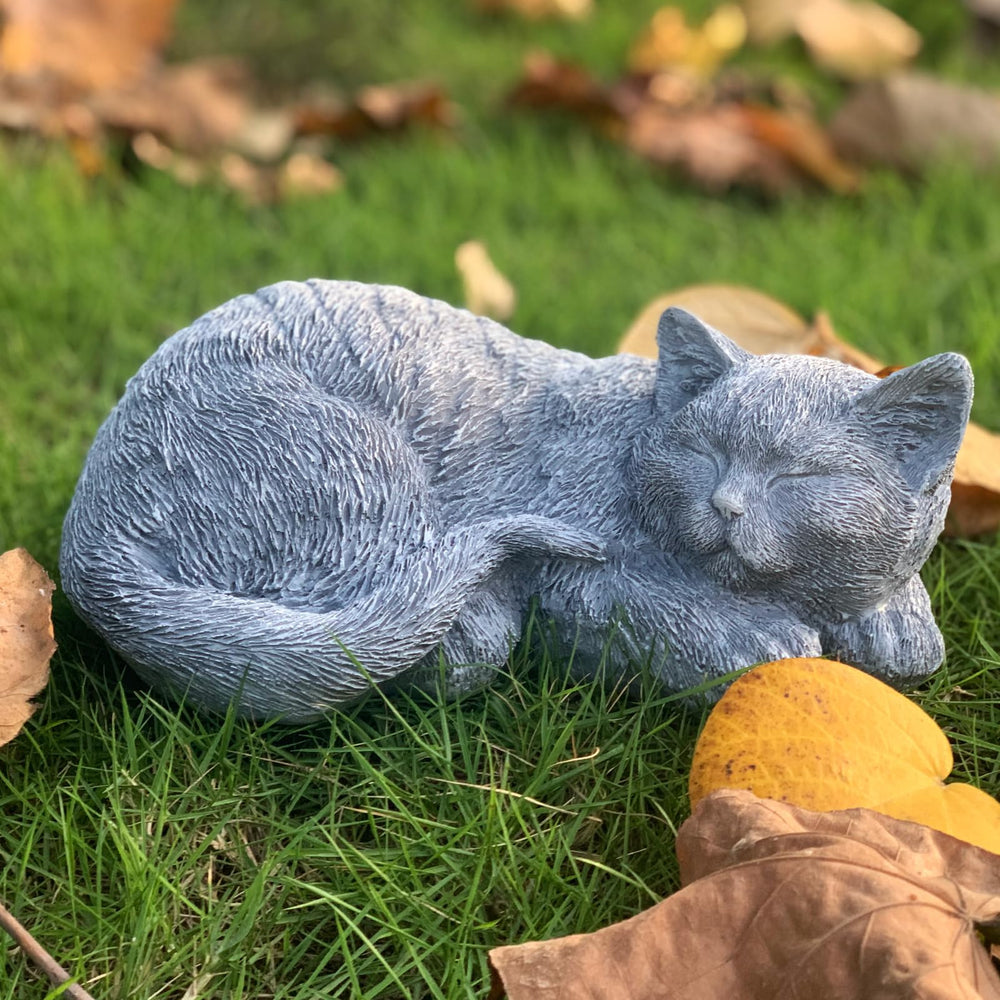 GARDEN WHISPER statue nestled in a flower bed enhancing garden memorials