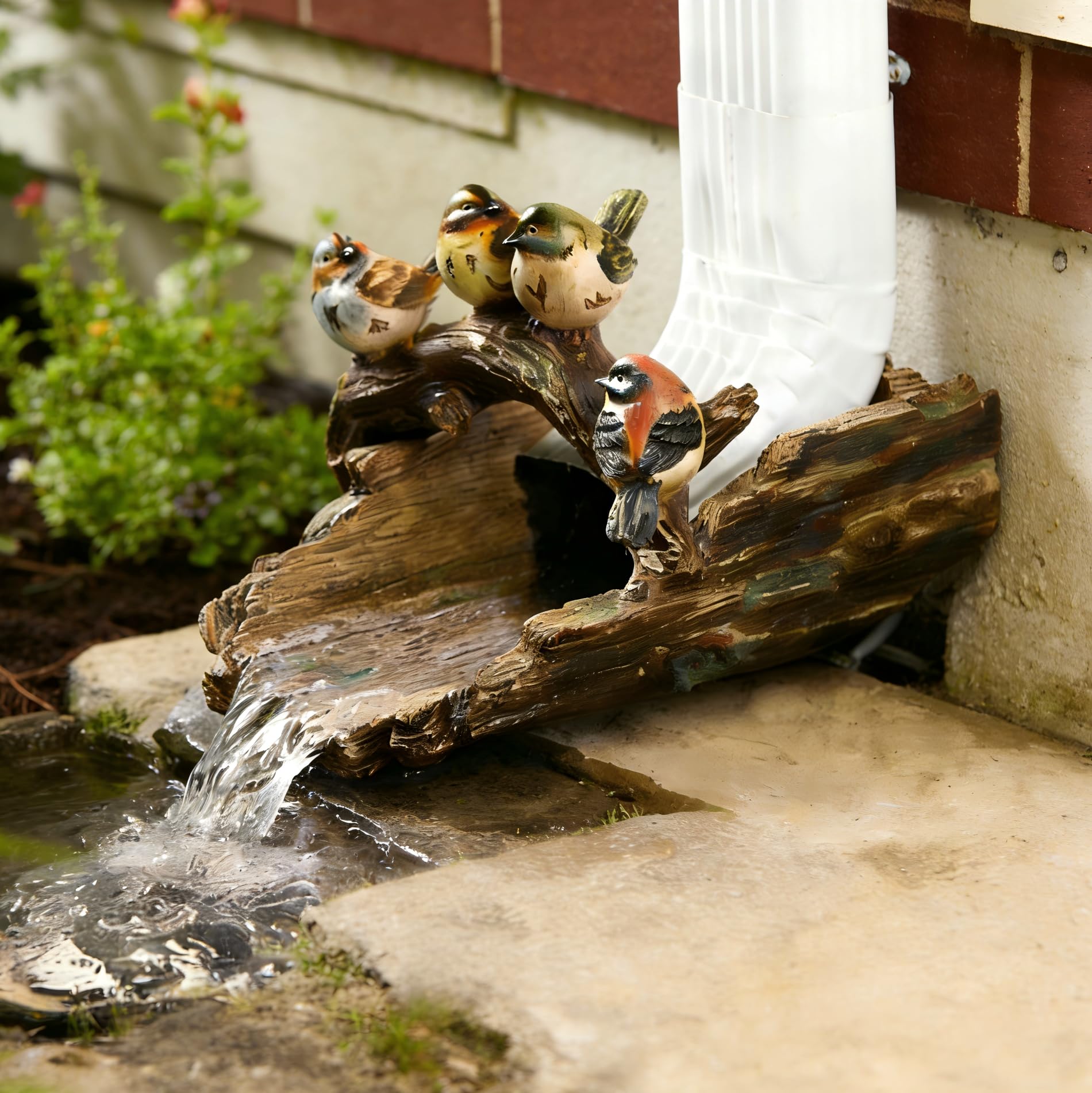 GARDEN WHISPER splash block in use under gutter effectively channeling rain away from home