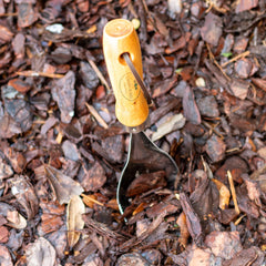 Garden Works Soil Scoop close-up of serrated 18-gauge blade cutting roots for precise soil work