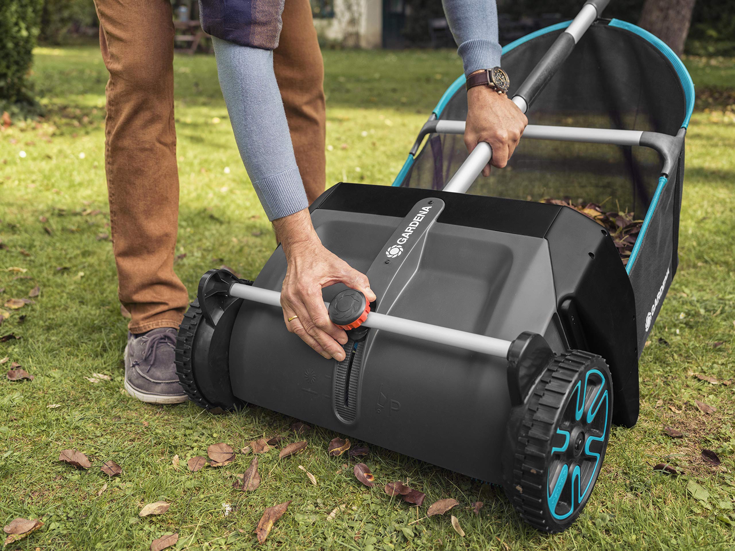 GARDENA sweeper staged in a tidy garden demonstrating quiet, eco-friendly maintenance