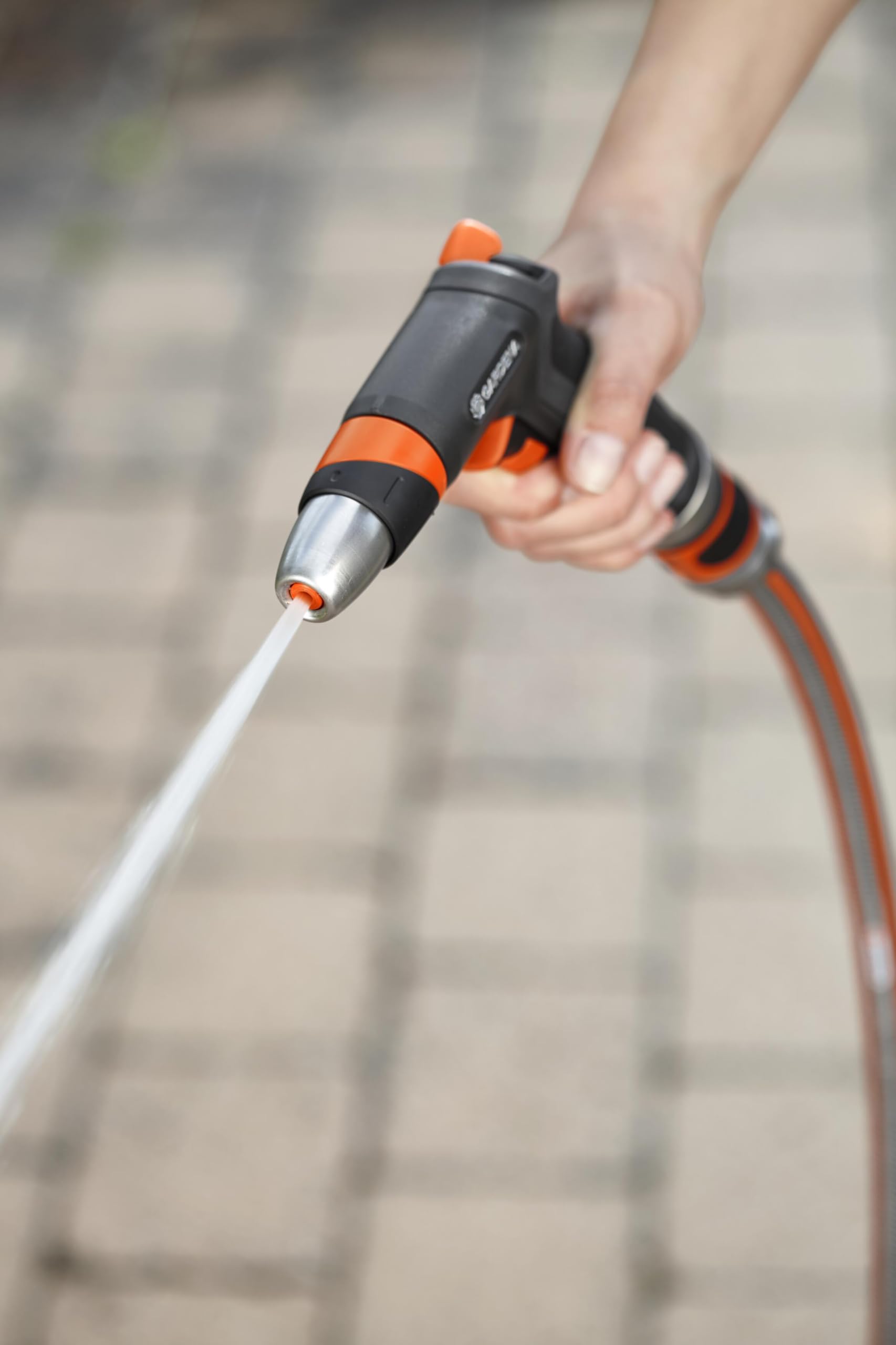 Gardena nozzle in use blasting a patio to remove dirt and grime efficiently