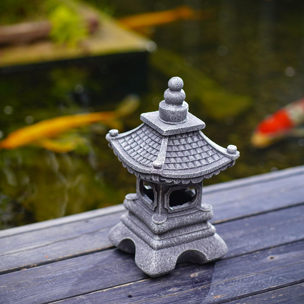 Gardenfans pagoda beside a hand to show compact size and easy placement