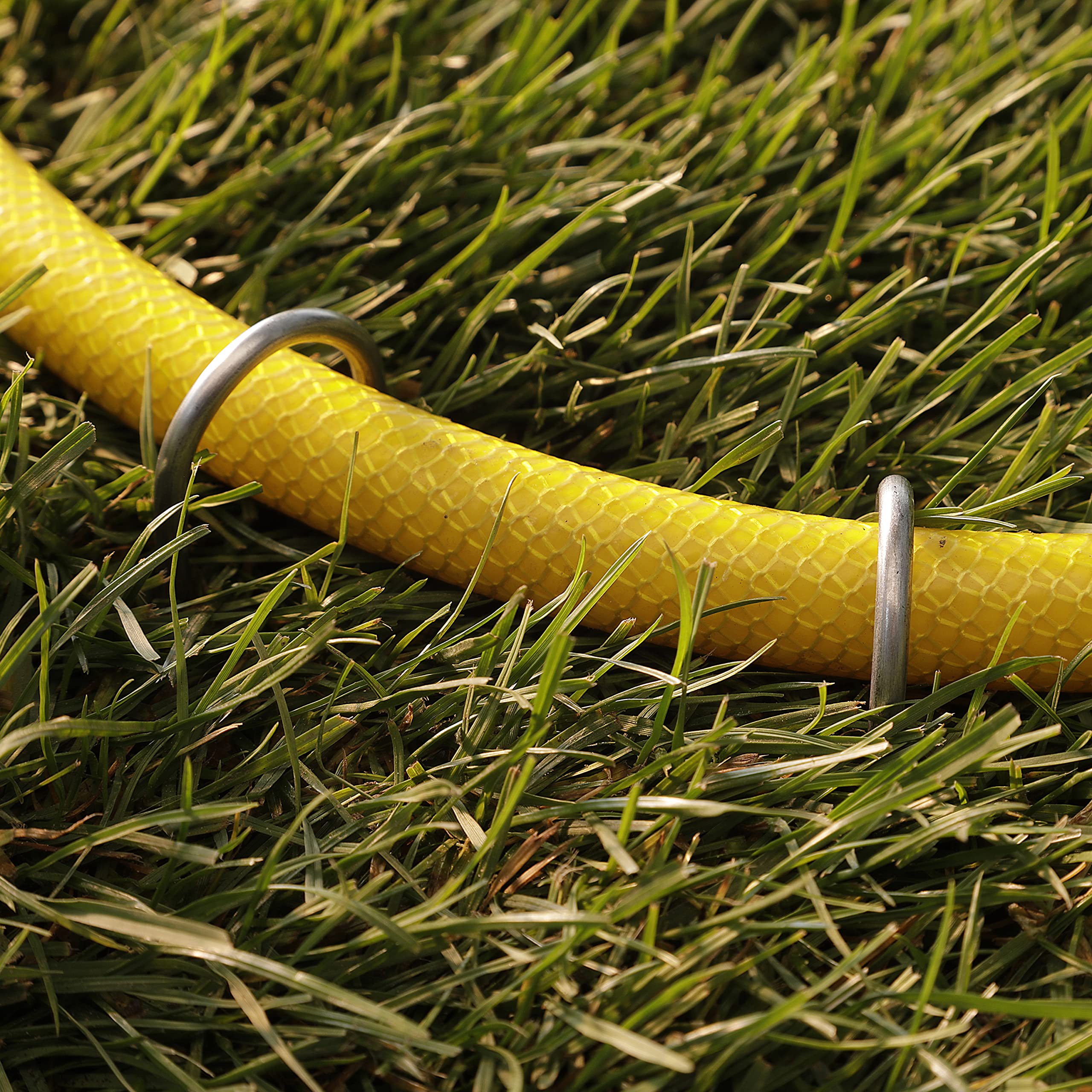 GardenMate anchored landscape fabric in use securing edges benefit