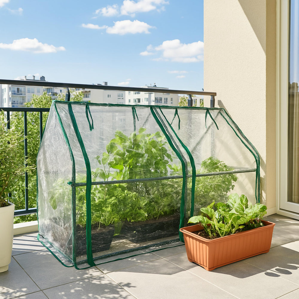 Gardzen greenhouse next to patio furniture showing compact size and placement flexibility