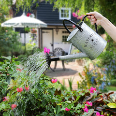 Garutom watering hanging plants demonstrating easy reach and gentle shower