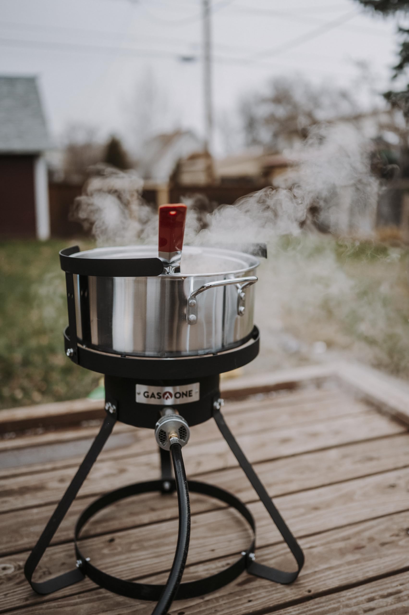 Gas One fryer in outdoor use frying chicken wings showing portability and party-ready benefit