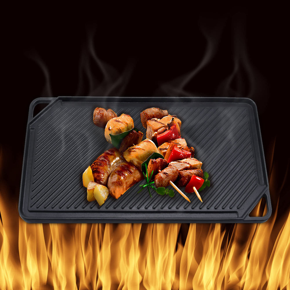 GasSaf griddle spanning two burners on stovetop demonstrating wide coverage and even heat