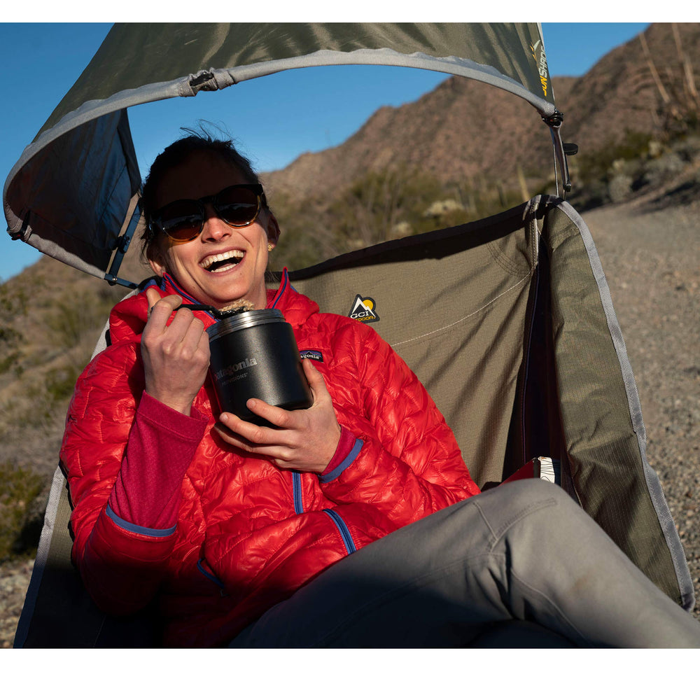 GCI Outdoor Pod Rocker next to backpack to show compact size and portability