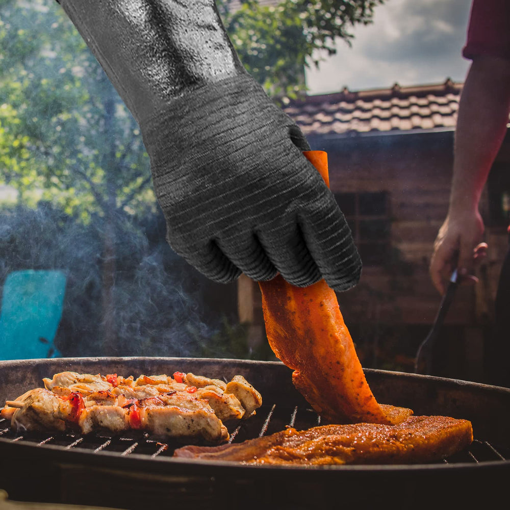 GEEKHOM gloves beside grill tools demonstrating size and heavy-item support