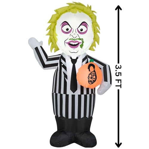 Gemmy Beetlejuice illuminated at night on lawn, glowing visibility for trick-or-treaters
