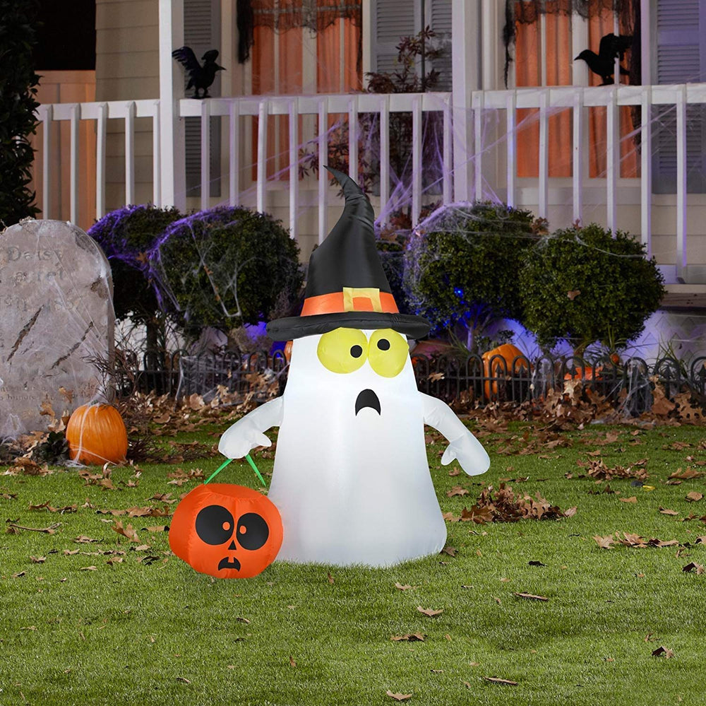 Gemmy inflatable ghost lit at night creating visible yard focal point