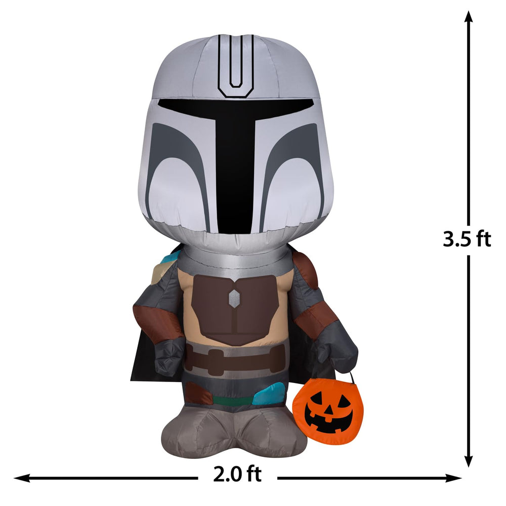 Gemmy Mandalorian lit in yard at night creating eye-catching Halloween display