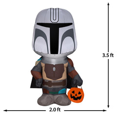 Gemmy Mandalorian lit in yard at night creating eye-catching Halloween display