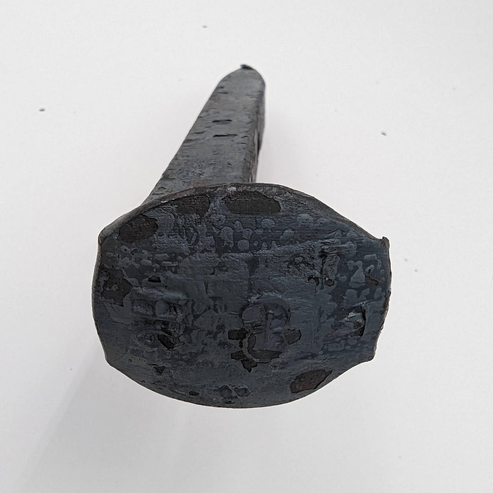 Generic brand spike mounted as rustic coat hanger demonstrating practical hardware use
