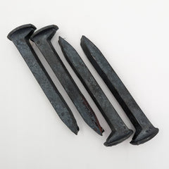 Generic brand front view of four new spikes showing heads and length, useful for crafting