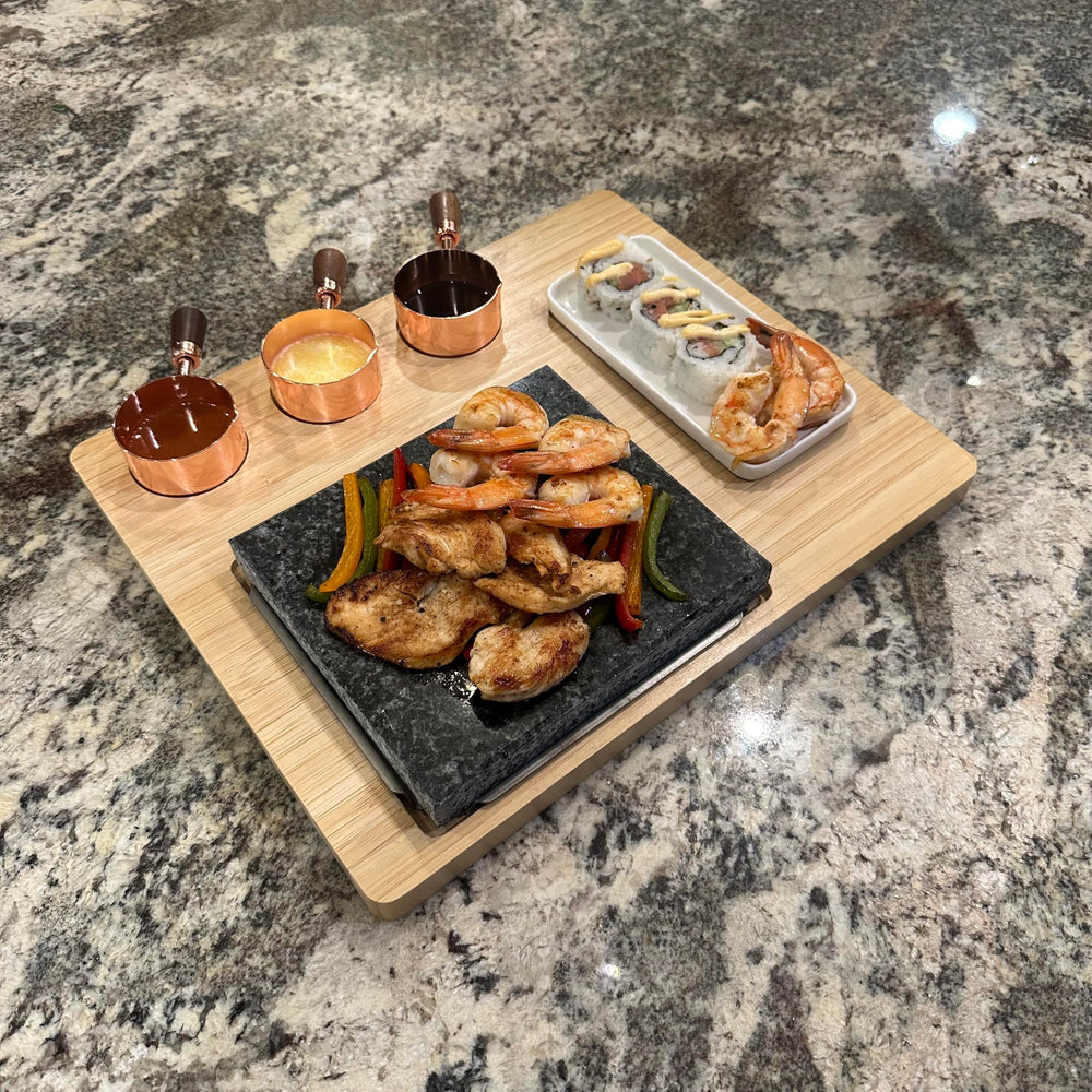 Generic tabletop in-use scene with steak and vegetables on stone, encourages interactive dining