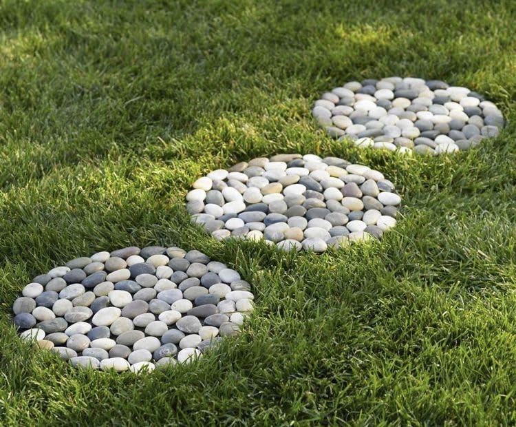 Generic brand stepping stones installed in garden path, demonstrates decorative walkway benefit