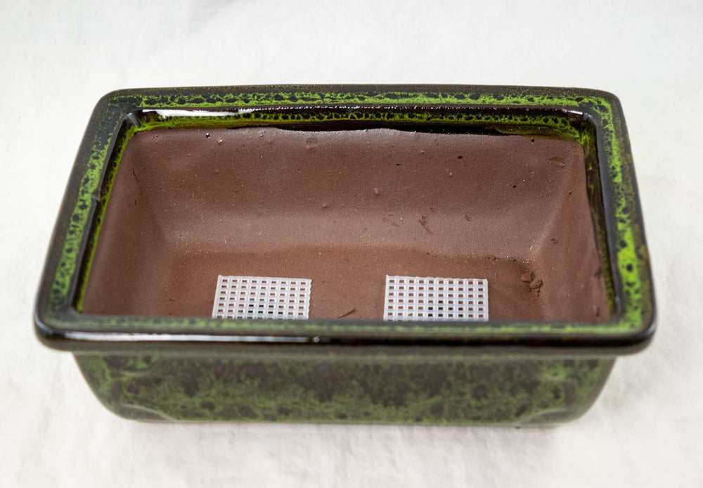 Generic image of 1.5" mesh covering drainage hole for soil retention