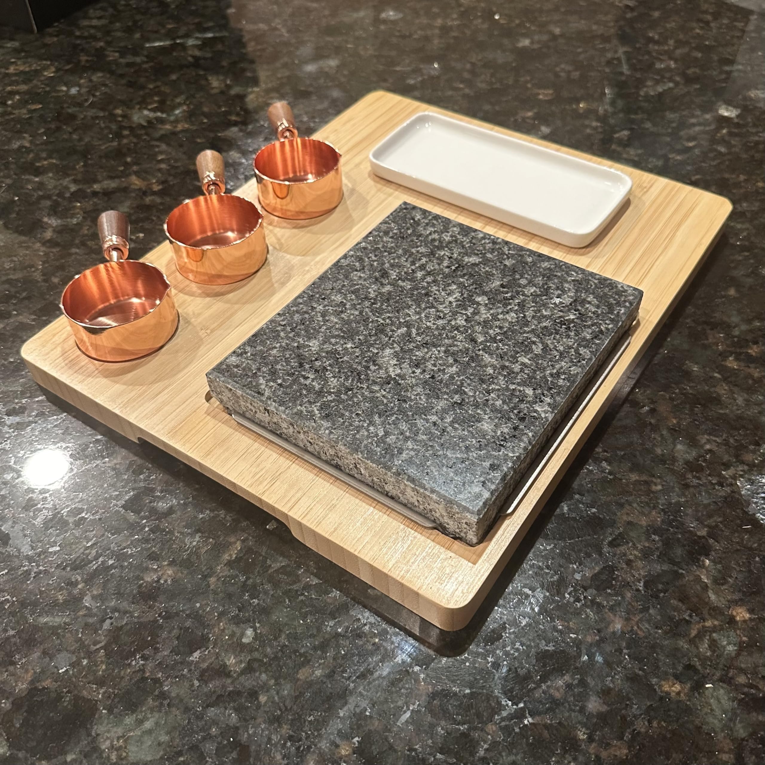 Generic granite slab next to utensils to show scale, helps visualize fit on dining table