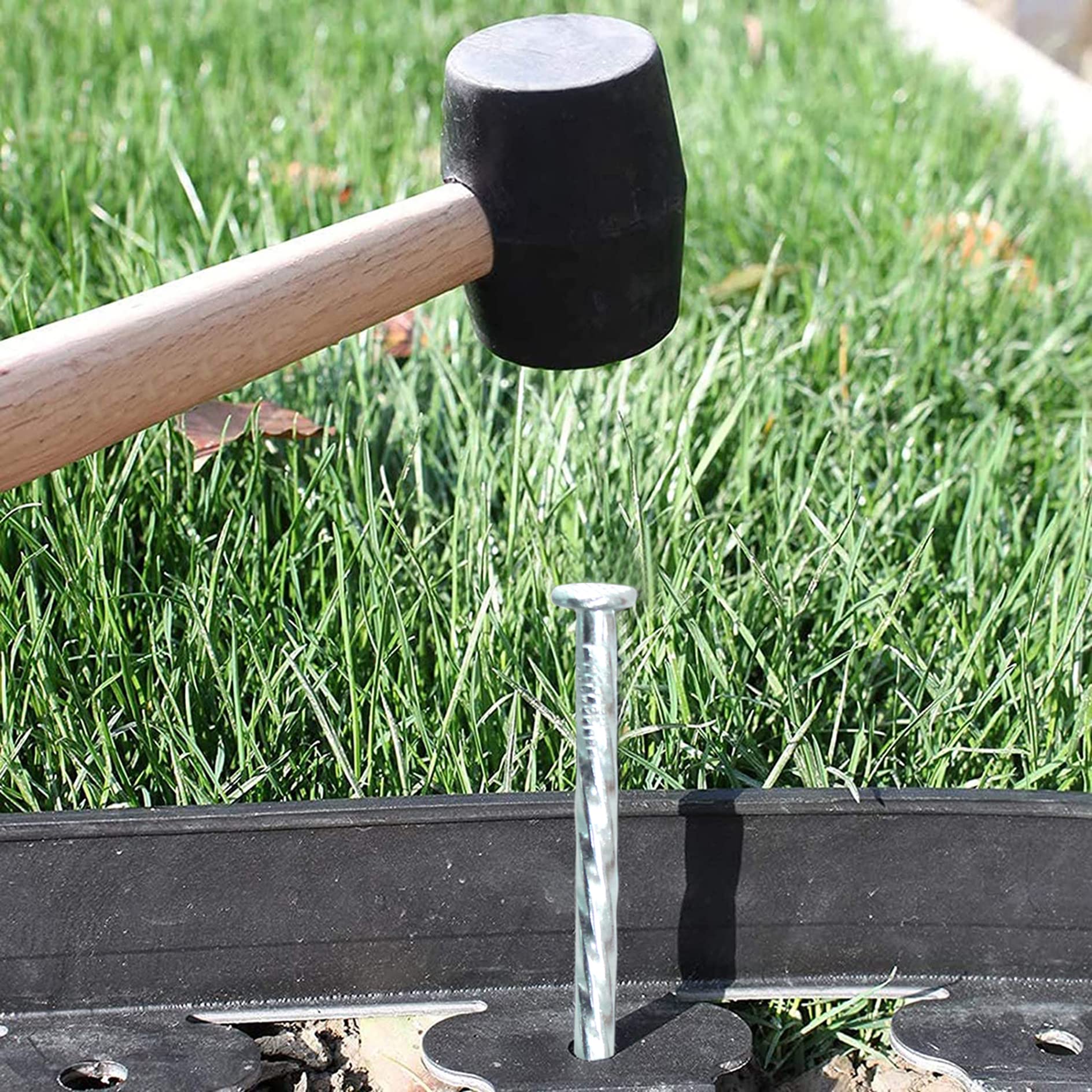 Generic stake next to hand and ruler showing 6-inch scale for correct sizing and easy planning