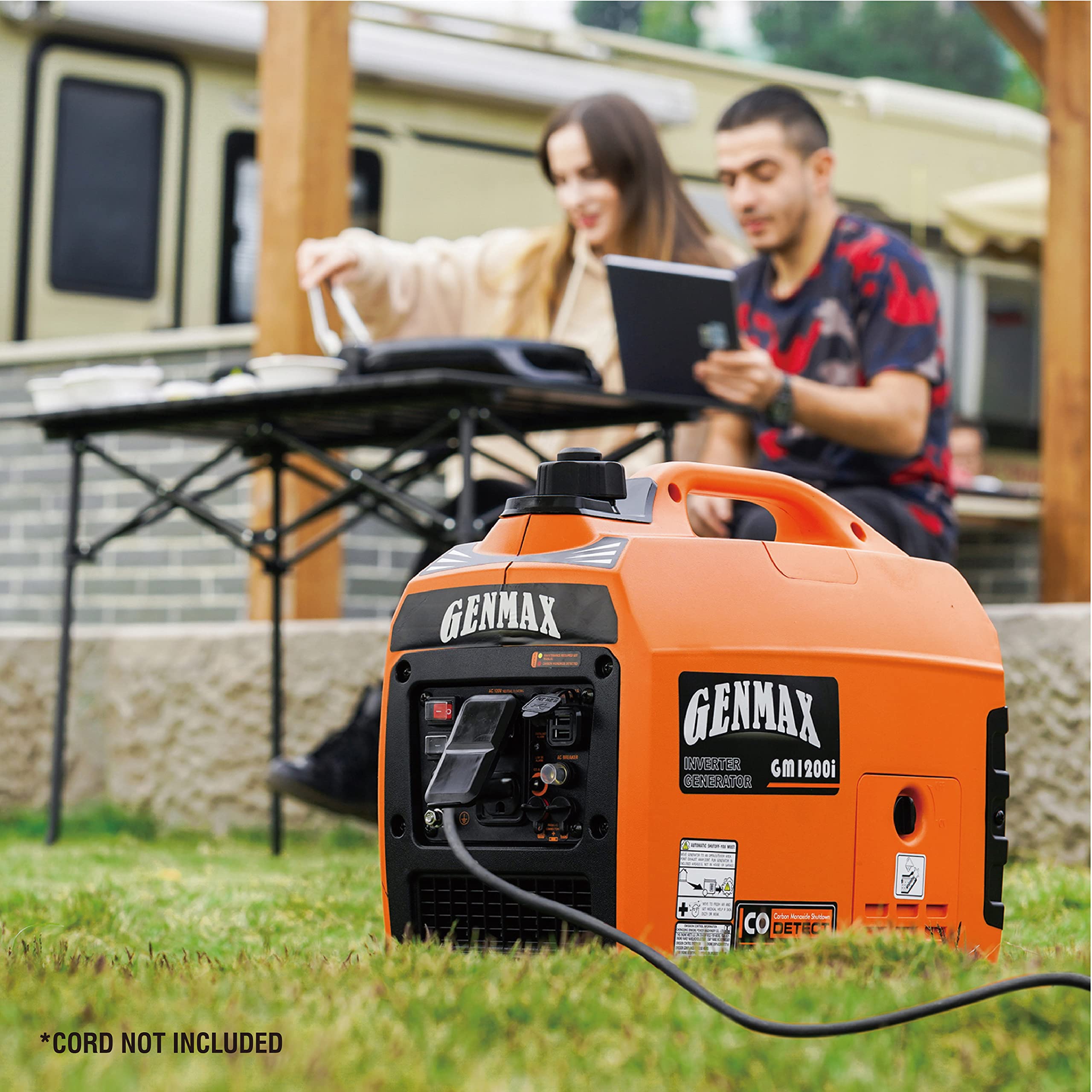 GENMAX GM1200i in a campsite powering lights and devices for quiet outdoor use