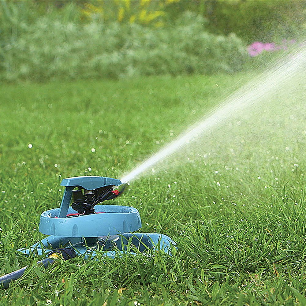 GILMOUR sprinkler in use watering large lawn for even landscape coverage