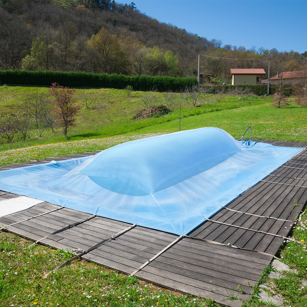 GJQ pillow under snowy pool cover in backyard showing protection from snow load
