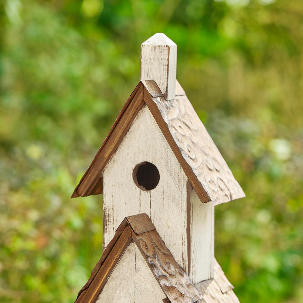 Glitzhome birdhouse staged in garden adding cottage-style focal point