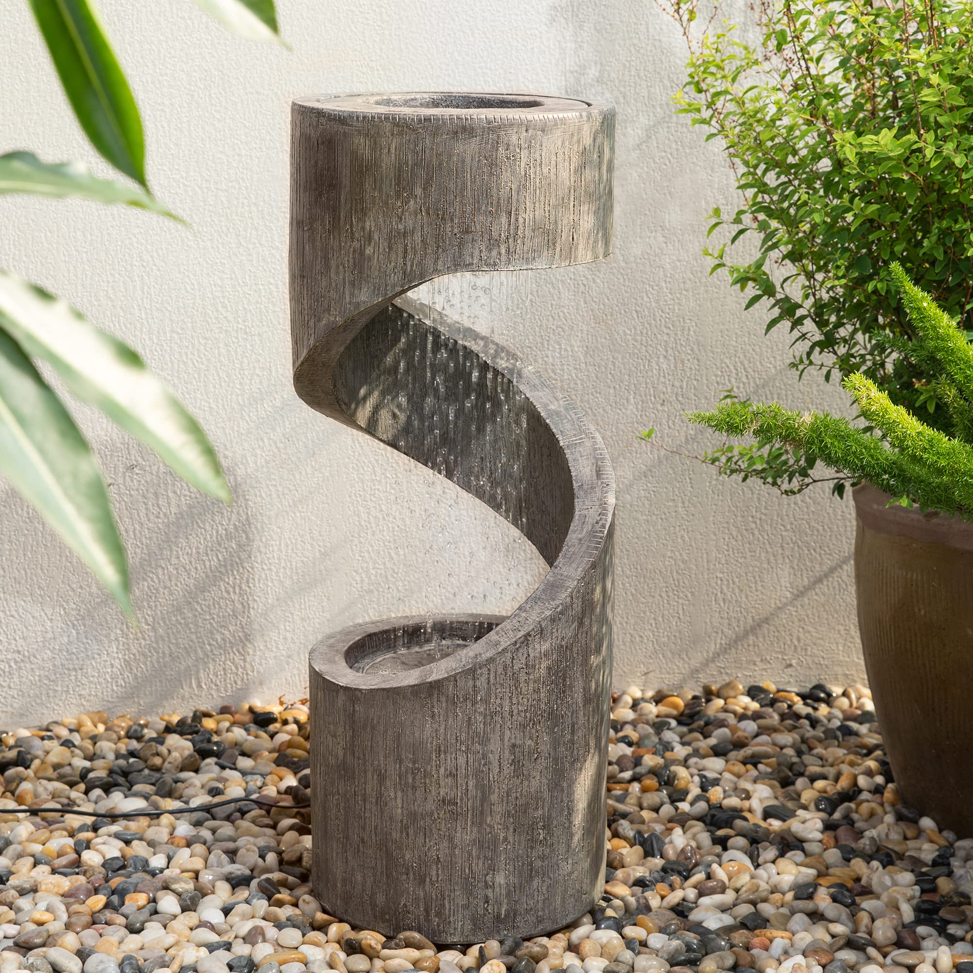 Glitzhome evening backyard setting with glowing fountain, enhances nighttime outdoor ambiance