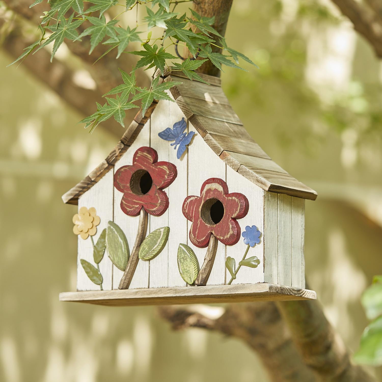 Glitzhome hanging on branch in garden attracting small birds and beautifying space