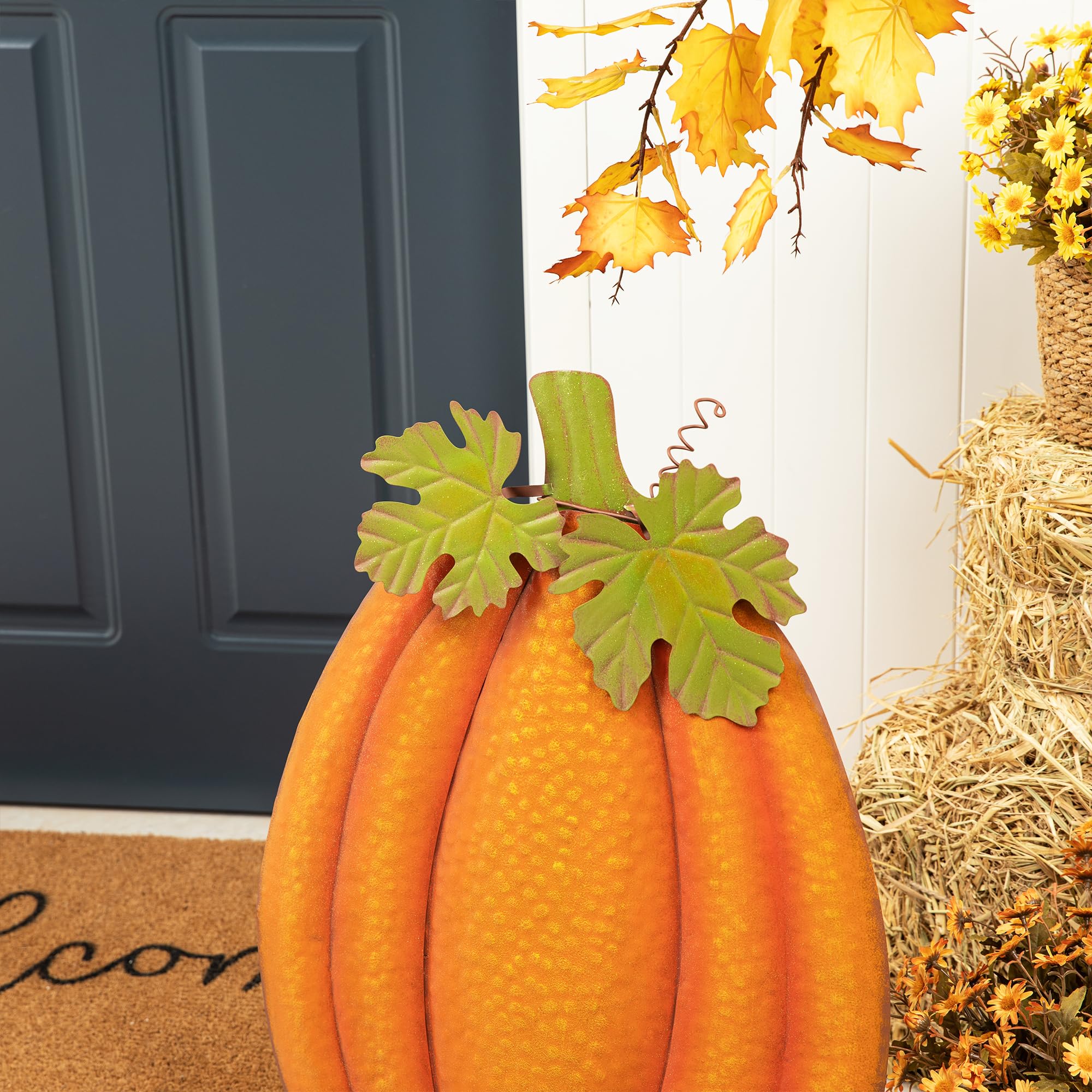 Glitzhome pumpkin along pathway adds seasonal color and charm