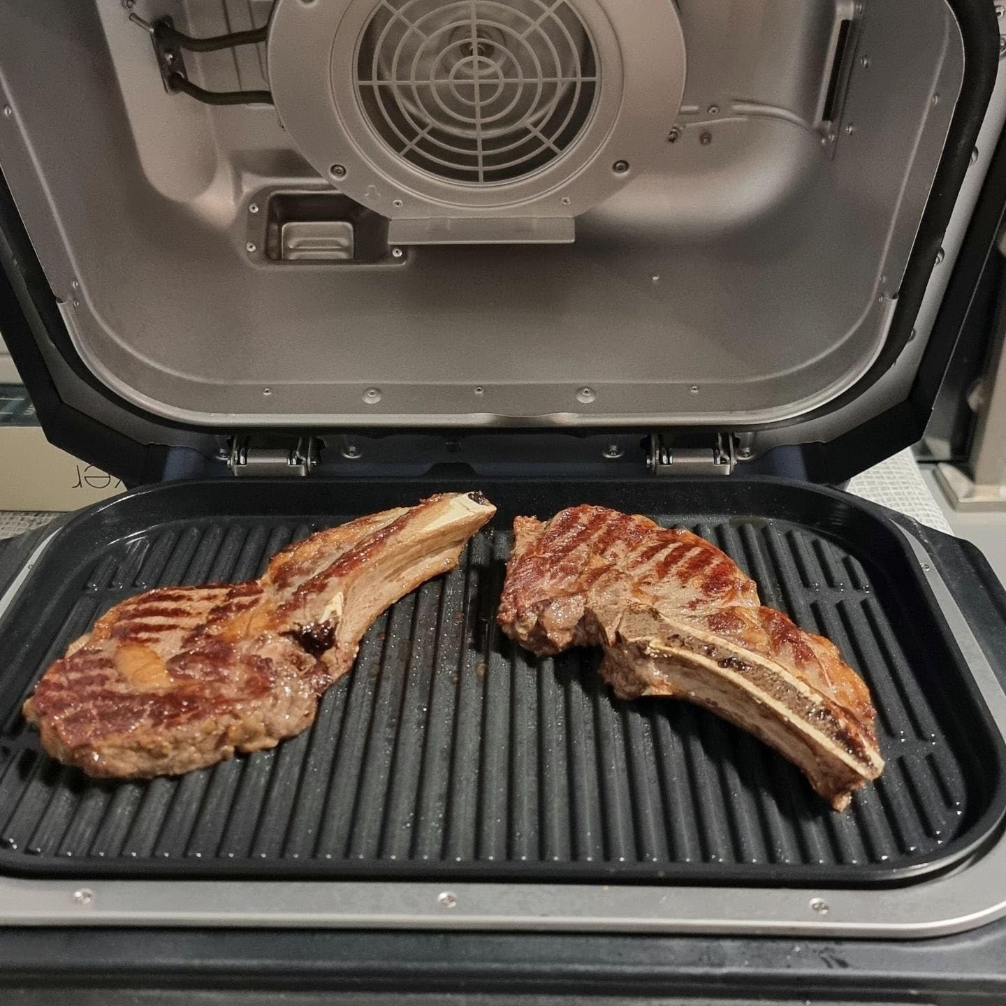 GLOWYE griddle installed on outdoor grill in backyard for social cooking