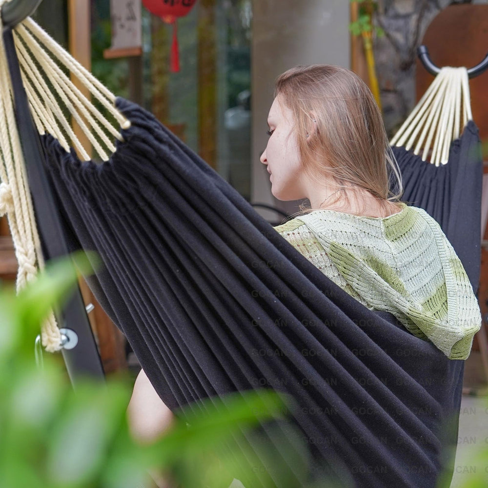 GOCAN hammock hung on a stand in a backyard for relaxed outdoor lounging