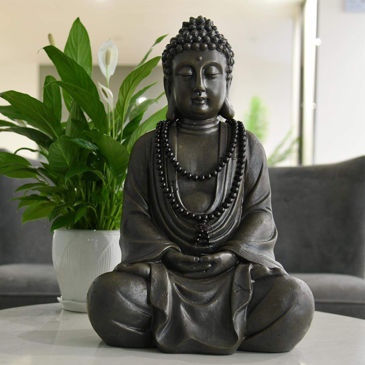 Goodeco Buddha placed in garden setting creating calm outdoor focal